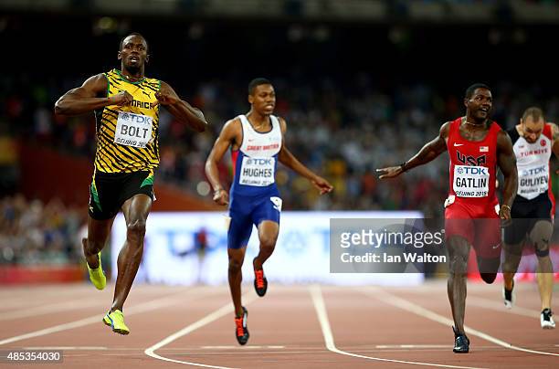 Usain Bolt of Jamaica crosses the finish line to win gold ahead of Justin Gatlin of the United States in the Men's 200 metres final during day six of...