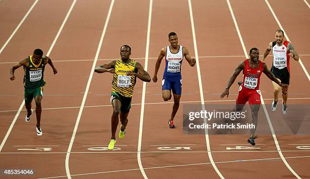 Usain Bolt of Jamaica crosses the finish line to win gold ahead of Justin Gatlin of the United States in the Men's 200 metres final during day six of...