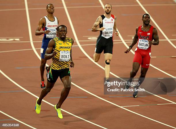 Usain Bolt of Jamaica crosses the finish line to win gold ahead of Justin Gatlin of the United States in the Men's 200 metres final during day six of...