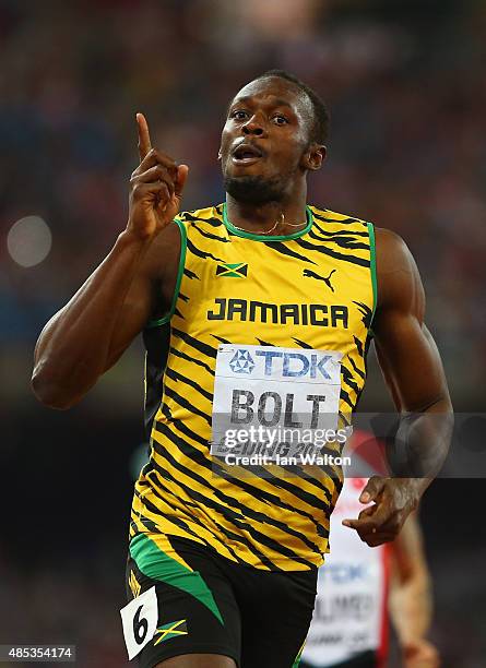 Usain Bolt of Jamaica celebrates after crossing the finish line to win gold in the Men's 200 metres final during day six of the 15th IAAF World...