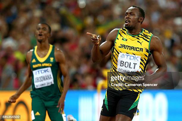 Usain Bolt of Jamaica celebrates after crossing the finish line to win gold in the Men's 200 metres final during day six of the 15th IAAF World...