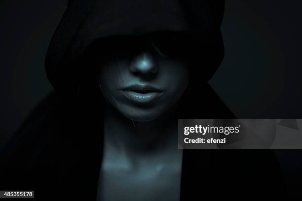 portrait of woman in darkness - fear face stock pictures, royalty-free photos & images