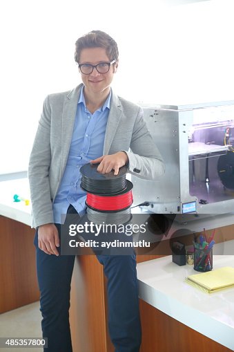 Young men using 3D printer Young men using 3D printer