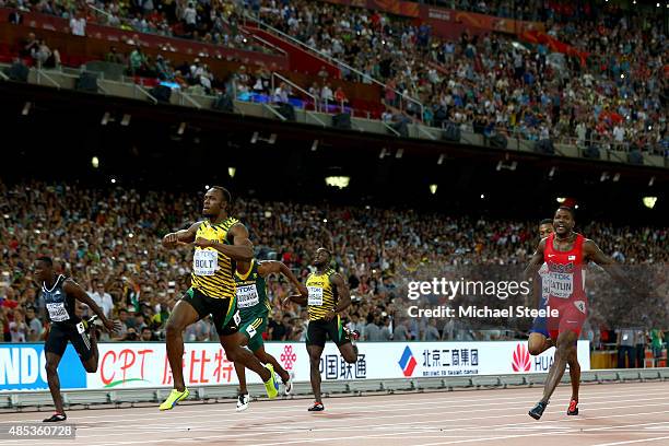 Usain Bolt of Jamaica crosses the finish line to win gold ahead of Justin Gatlin of the United States in the Men's 200 metres final during day six of...