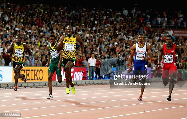 Usain Bolt of Jamaica crosses the finish line to win gold ahead of second place Justin Gatlin of the United States and Anaso Jobodwana of South...