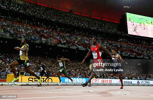 Usain Bolt of Jamaica crosses the finish line to win gold ahead of second place Justin Gatlin of the United States and Anaso Jobodwana of South...