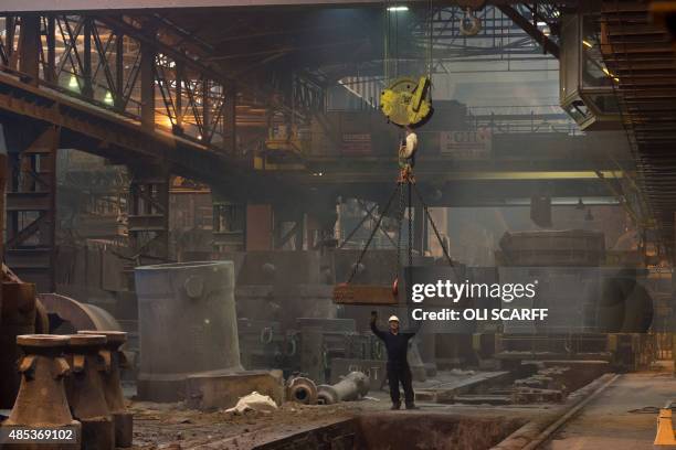 Worker sets a pit for casting a steel ingot in the Melt Shop at Sheffield Forgemasters International Ltd. In Sheffield, northern England on August...