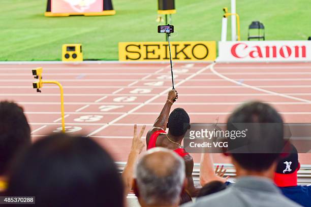 Justin Gatlin of the United States takes a selfie with fans after he won silver in the Men's 200 metres final during day six of the 15th IAAF World...