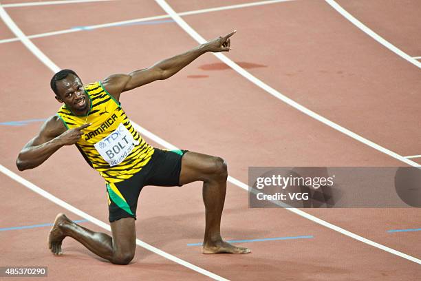 Usain Bolt of Jamaica celebrates after crossing the finish line to win gold in the Men's 200 metres final during day six of the 15th IAAF World...