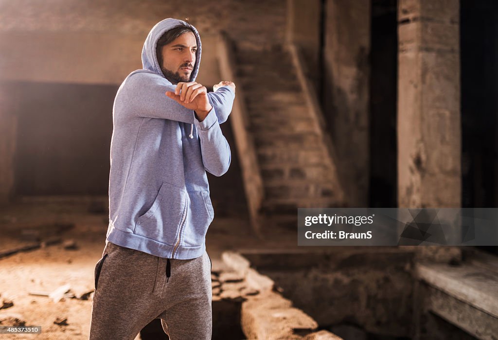 Young athletic man warming up before exercising.