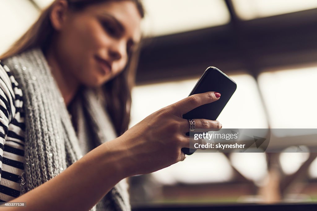 Close-up of woman text messaging on mobile phone.