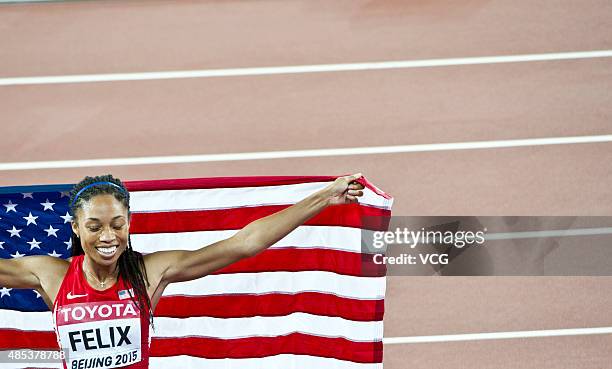 Allyson Felix of the United States celebrates after winning gold in the Women's 400 metres Final during day six of the 15th IAAF World Athletics...