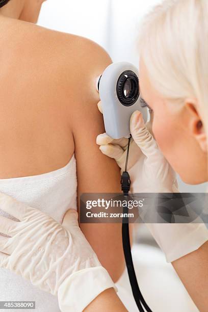 dermatologist checking for skin cancer - skin cancer face 個照片及圖片檔