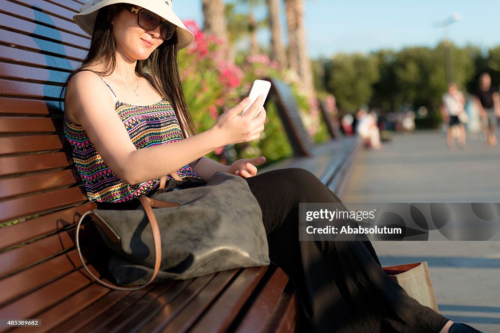 Chinese Tourist with Hat Using Smart Phone, Koper, Slovenia, Europe