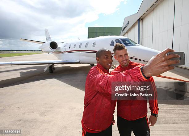 Ashley Young and Morgan Schneiderlin of Manchester United take a selfie in front of a private plane, as they depart for the official launch of the...