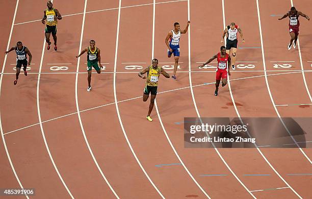 Usain Bolt of Jamaica crosses the finish line to win gold ahead of second place Justin Gatlin of the United States and Anaso Jobodwana of South...