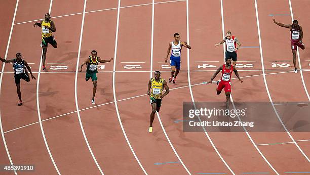 Usain Bolt of Jamaica crosses the finish line to win gold ahead of second place Justin Gatlin of the United States and Anaso Jobodwana of South...