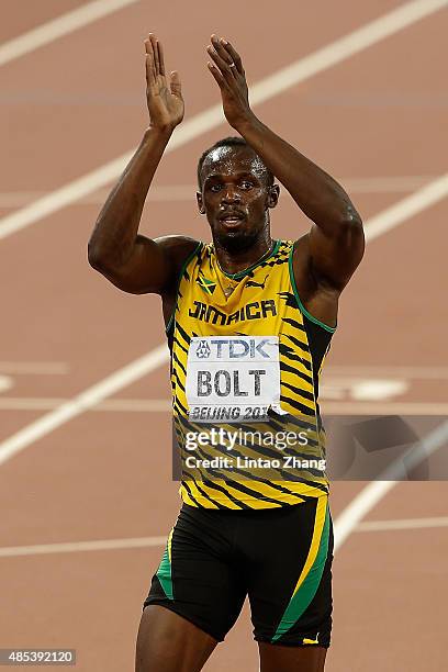 Usain Bolt of Jamaica celebrates after crossing the finish line to win gold in the Men's 200 metres final during day six of the 15th IAAF World...