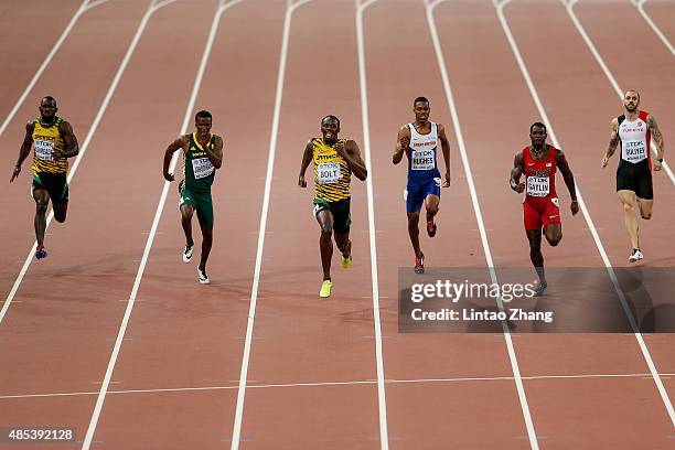 Usain Bolt of Jamaica crosses the finish line to win gold ahead of second place Justin Gatlin of the United States and Anaso Jobodwana of South...