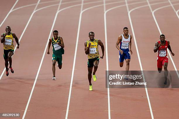 Usain Bolt of Jamaica crosses the finish line to win gold ahead of second place Justin Gatlin of the United States and Anaso Jobodwana of South...