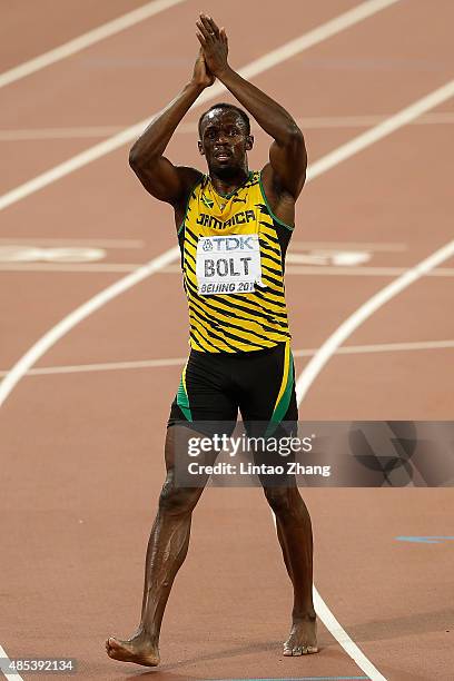 Usain Bolt of Jamaica celebrates after crossing the finish line to win gold in the Men's 200 metres final during day six of the 15th IAAF World...