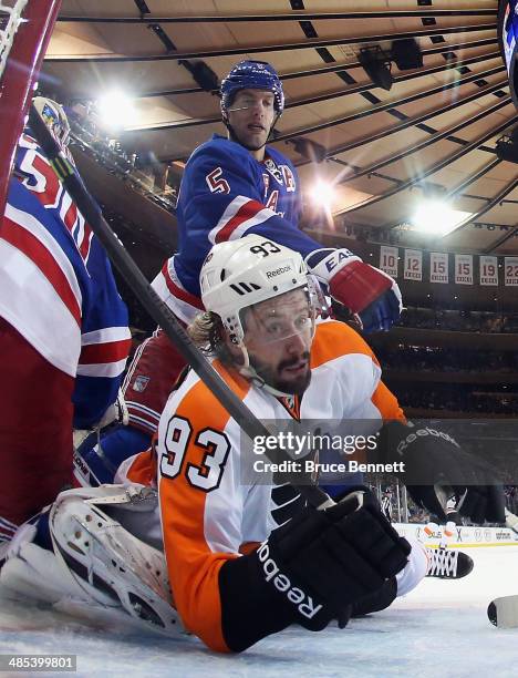 Jakub Voracek of the Philadelphia Flyers is hit by Dan Girardi of the New York Rangers in Game One of the First Round of the 2014 NHL Stanley Cup...