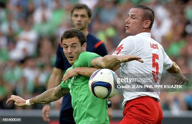 Saint-Etienne's French forward Nolan Roux vies for the ball with Milsami Orhei's Moldovan defender Petru Racu during the UEFA Europa League playoff...