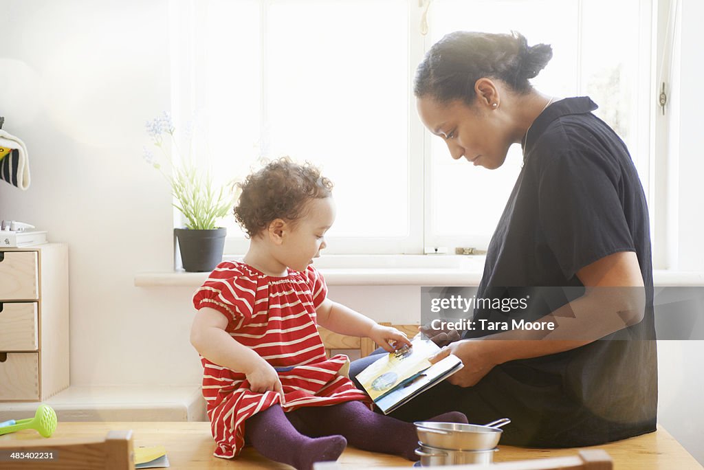 Mother showing child a book