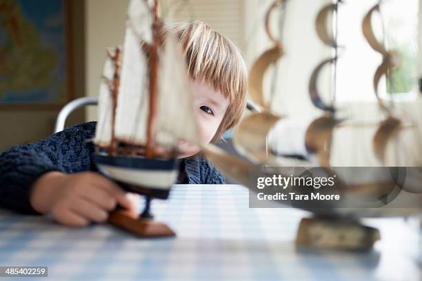 young boy playing with toy ships - pirate ship interior stock pictures, royalty-free photos & images