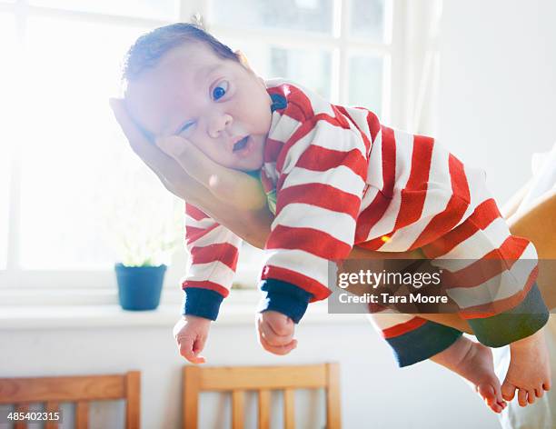 baby resting on mother's arm - baby clothing stock pictures, royalty-free photos & images