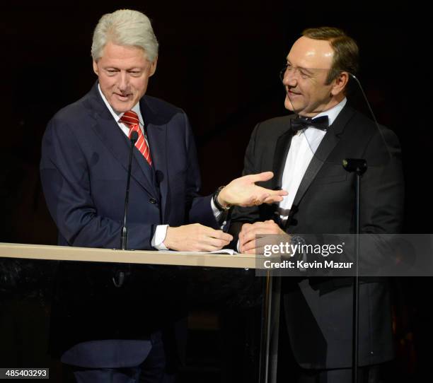 Former United States President Bill Clinton speaks onstage with Kevin Spacey during The 2014 Revlon Concert For The Rainforest Fund at Carnegie Hall...