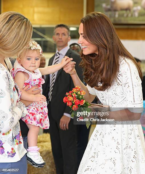 Catherine, Duchess of Cambridge is presented with flowers by a young girl as she visits the Sydney Royal Easter Show on April 18, 2014 in Sydney,...