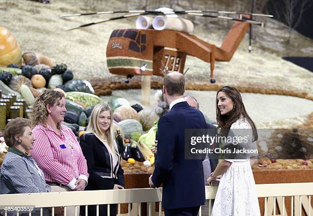 Catherine, Duchess of Cambridge and Prince William, Duke of Cambridge walk past a 'grain helicopter' on as they visit the Sydney Royal Easter Show on...