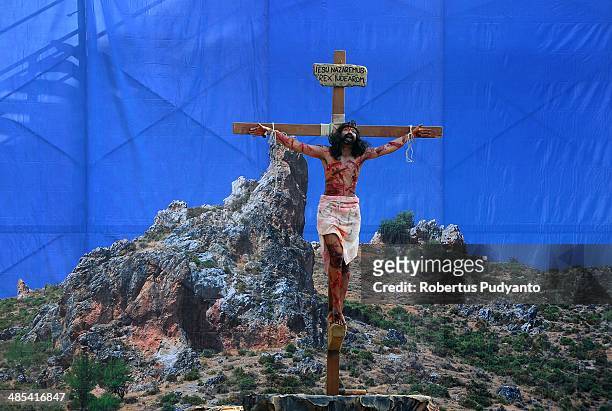 Indonesian Catholics devotees participate in a re-enactment of the crucifixion of Jesus Christ on Good Friday procession at Saint Matius Evangelists...