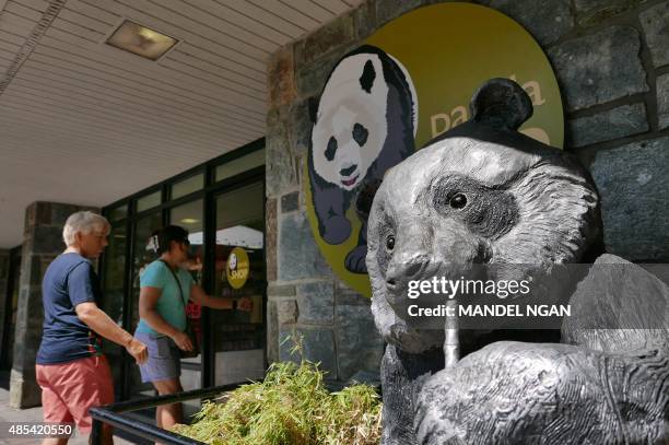 Patrons enter a gift shop at the National Zoo on August 27, 2015 in Washington, DC. One of the two giant panda twins born at Washington's Smithsonian...