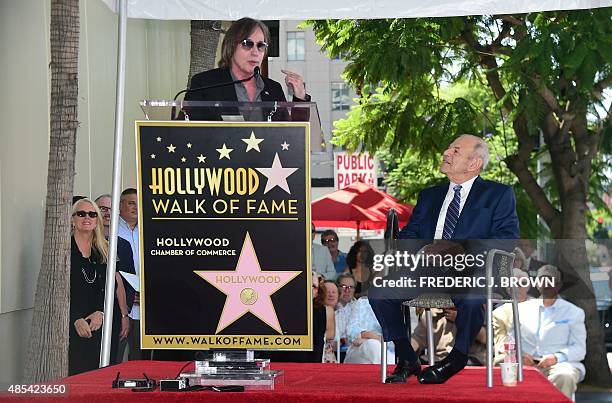 Music executive Joe Smith watches as musician Jackson Brown addresses the audience during Smith's Hollywood Walk of Fame Star ceremony in Hollywood,...
