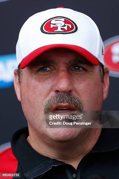 Head coach Jim Tomsula of the San Francisco 49ers talks to the media following a joint training session with the San Francisco 49ers and the Denver...