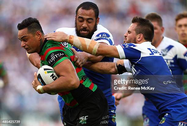 Souths captain John Sutton is tackled by Sam Kasiano and Josh Reynolds during the round seven NRL match between the South Sydney Rabbitohs and the...