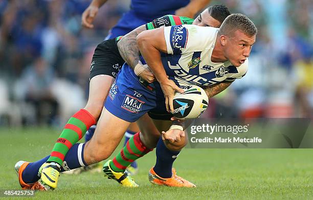 Trent Hodkinson of the Bulldogs is tackled by Adam Reynolds of the Rabbitohs during the round seven NRL match between the South Sydney Rabbitohs and...