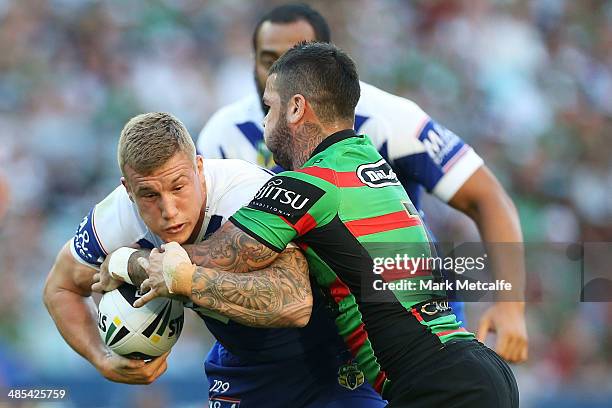 Trent Hodkinson of the Bulldogs is tackled by Adam Reynolds of the Rabbitohs during the round seven NRL match between the South Sydney Rabbitohs and...