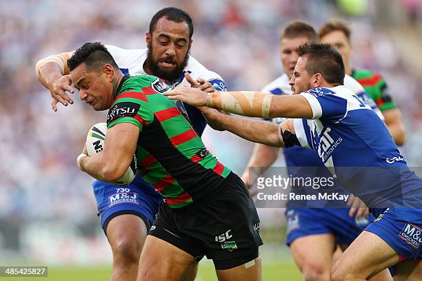 Souths captain John Sutton is tackled by Sam Kasiano and Josh Reynolds during the round seven NRL match between the South Sydney Rabbitohs and the...