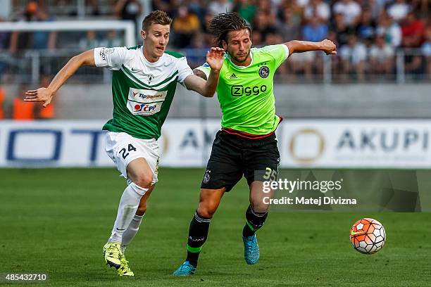Jan Gregus of FK Jablonec battles for the ball with Mitchell Dijks of Ajax Amsterdam during the UEFA Europa League Play Off Round 2nd Leg match...