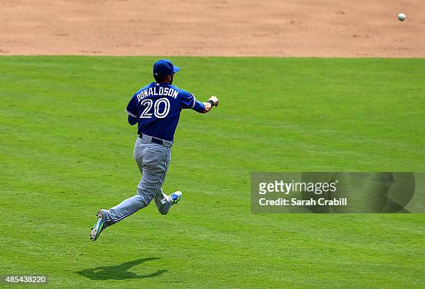 Josh Donaldson of the Toronto Blue Jays throws for an out at first base in the fifth inning during a game against the Texas Rangers at Globe Life...