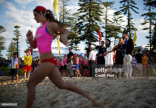 Prince William, Duke of Cambridge and his wife Catherine, Duchess of Cambridge watch a beach sprint race with Australian surf lifesaver Naomi Flood...