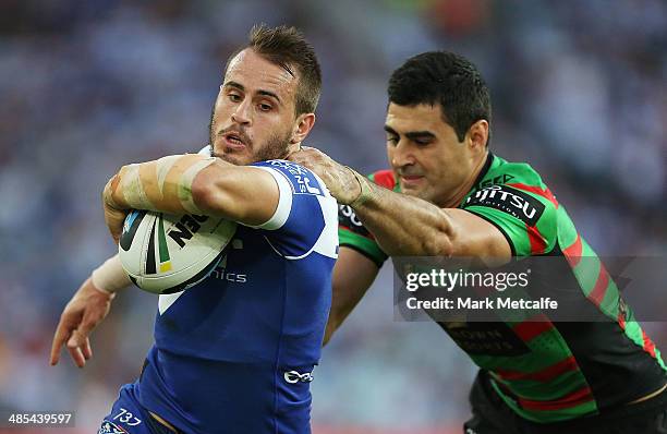 Josh Reynolds of the Bulldogs is tackled by Bryson Goodwin of the Rabbitohs during the round seven NRL match between the South Sydney Rabbitohs and...