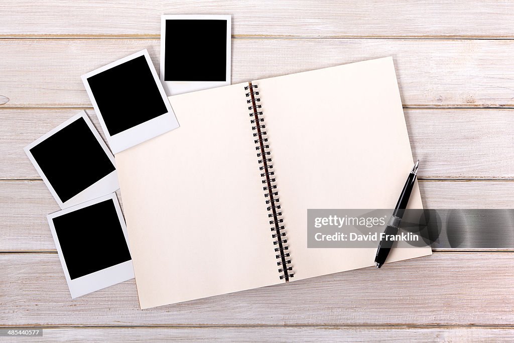 Photo album with blank photo prints