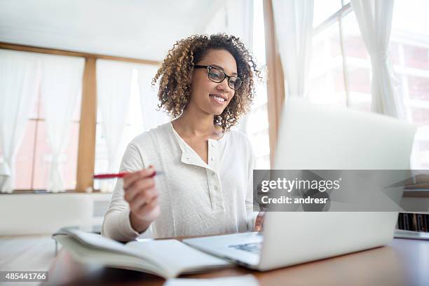 woman studying online at home - medical student stockfoto's en -beelden