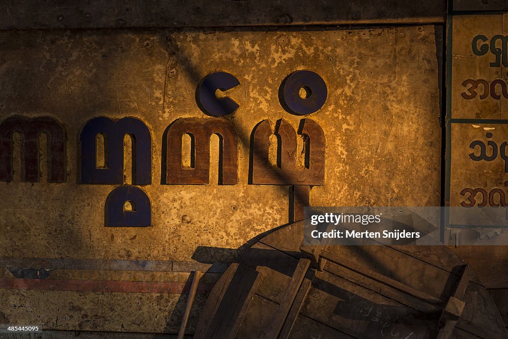 Myanmarian letters on store in sunlight