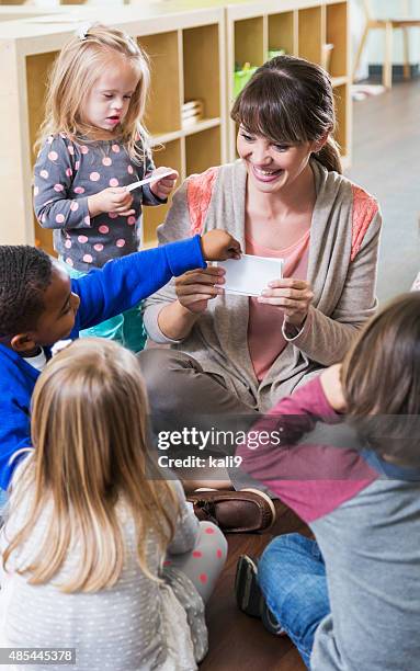 special needs child in preschool class with group - children circle floor stock pictures, royalty-free photos & images