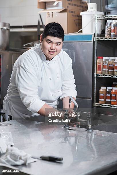 asian chef washing hands in kitchen sink - chubby hands stock pictures, royalty-free photos & images